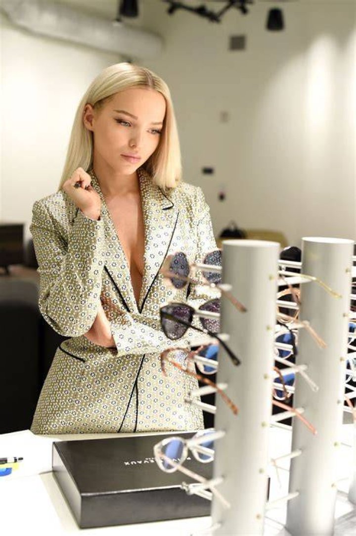 Dove Cameron Wearing Sunglasses on the Couch
