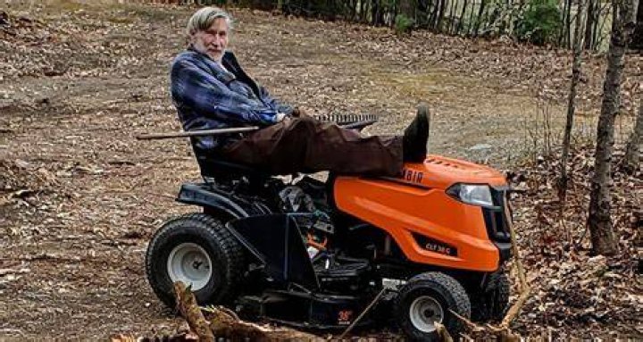 Geoffrey Holt On A Lawnmower