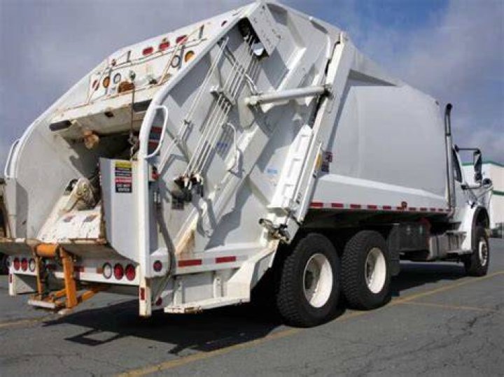 Why do garbage trucks have two steering wheels?